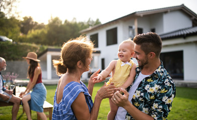 Portrait of multigeneration family outdoors on garden barbecue.