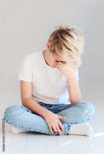 handsome teenager boy sitting on the floor
