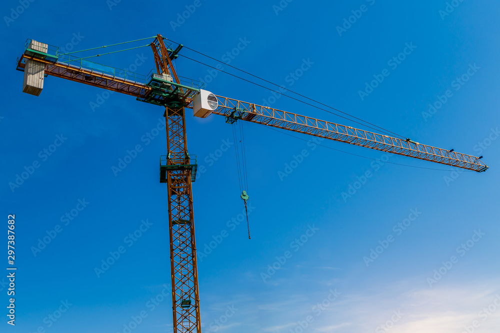 Construction site background. Hoisting cranes and new multi-storey buildings. I.ndustrial background.Building construction site work against blue sky Construction site background. Hoisting cranes and new multi-storey buildings. I.ndustrial background.Building construction site work against blue sky