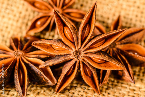 Star anise. Some star anise fruits. Macro close-up on the jute burlap surface in rustic style.
