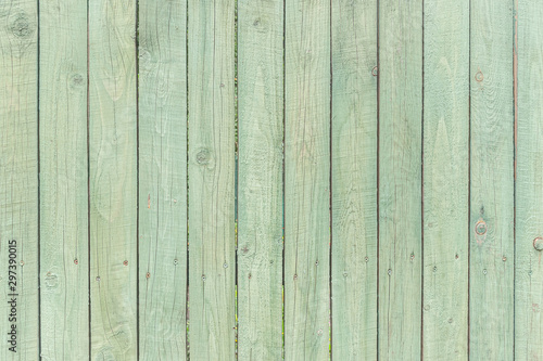 abstract background of painted in turquoise color wooden fence close up