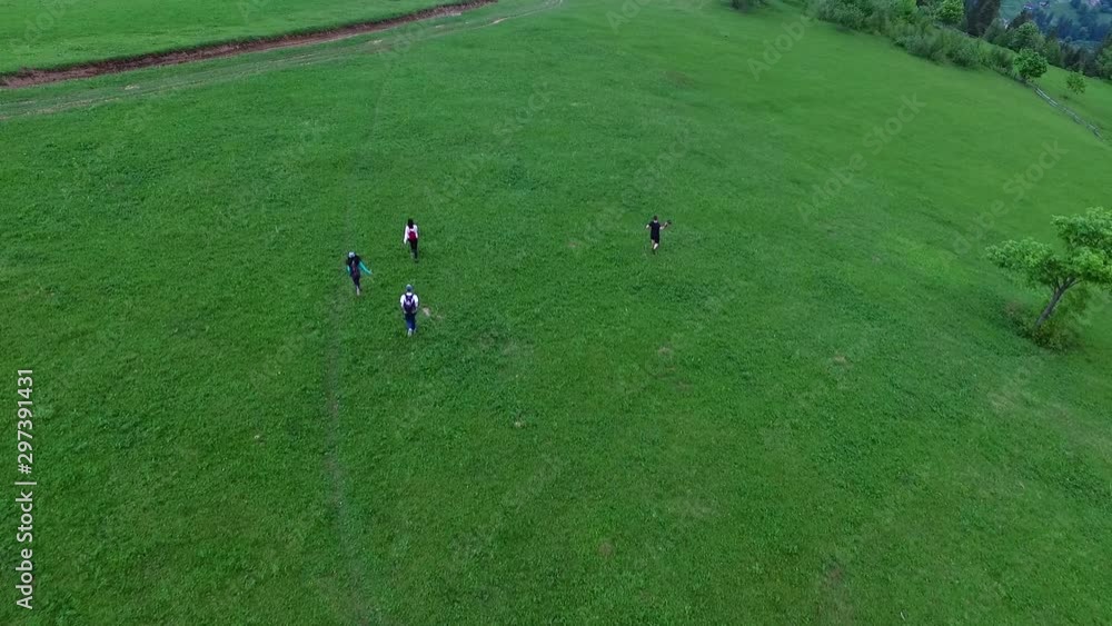 Drone shot of five friends descending down a mountain Drone shot of five friends descending down a mountain