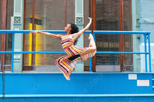 Dancer leaping with knees bent