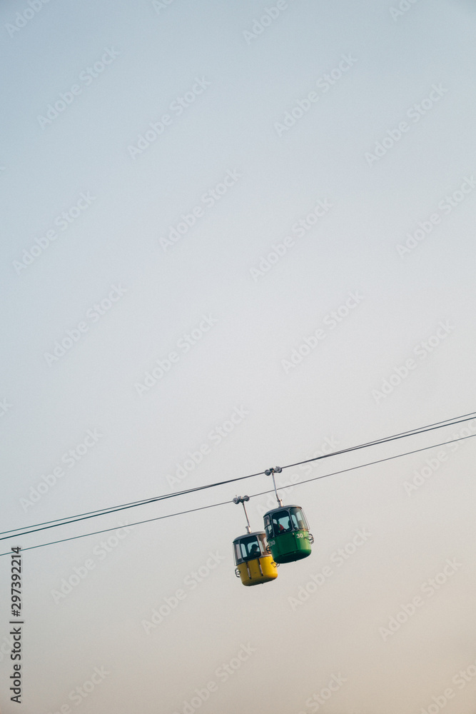 Tilt shift view of cable cars carrying passengers Tilt shift view of cable cars carrying passengers