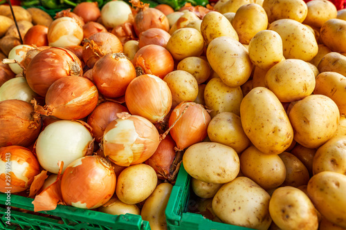 Potato and onion on a market counter. Close-up. Background. Space for text.