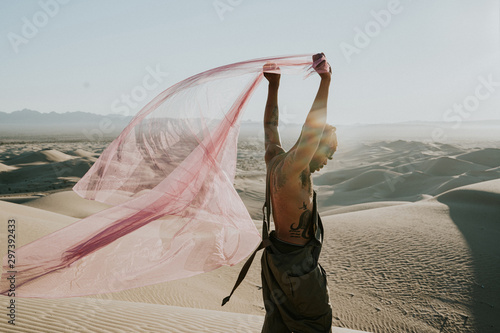Side view of man holding net in desert photo