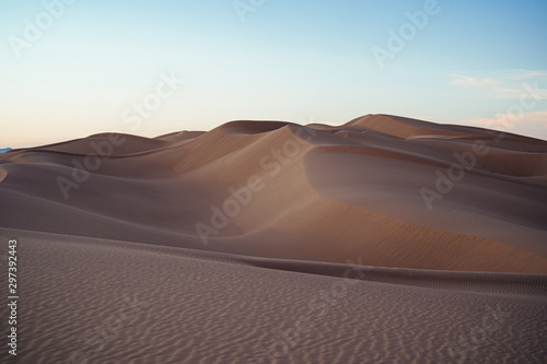 Sand dunes in desert photo