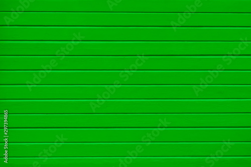 rough wooden timber green background , bright and colotful log wall texture , beam walls close up for building design