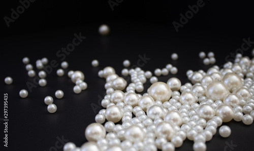 Bunch of multi size pearls on a background.Glamorous pearls milky-way.luxury lifestyle.Holiday decoration.Nice and shiny romantic morning.Love and success. photo