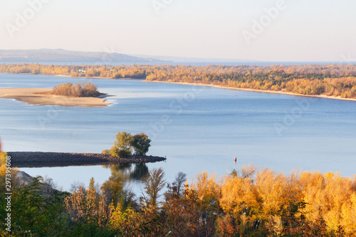 Golden autumn in Ukraine. View of the Dnieper, a small island and yellow trees in the city of Kanev, Ukraine.