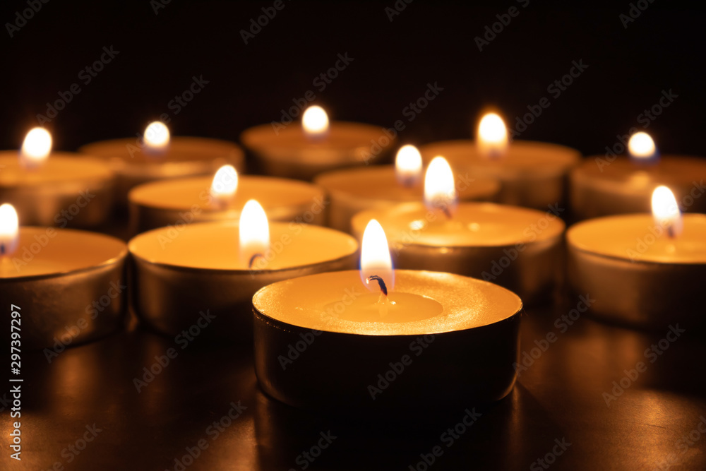 Paraffin candles on a dark table, close-up. Symbol of memory. Paraffin candles on a dark table, close-up. Symbol of memory.