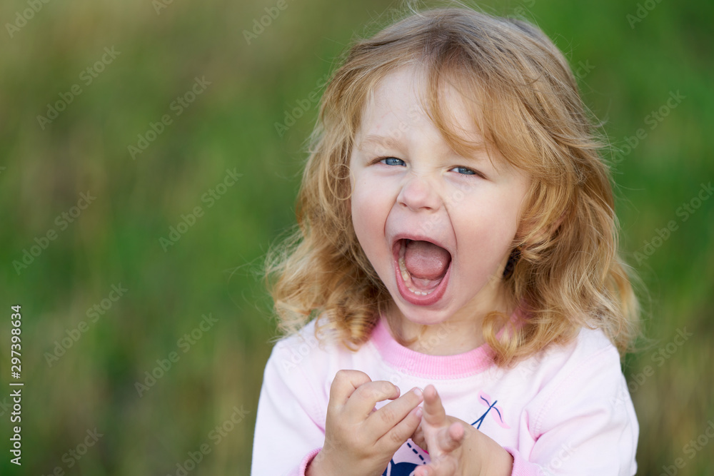 Portrait of a little smiling girl growls like a tiger Portrait of a little smiling girl growls like a tiger