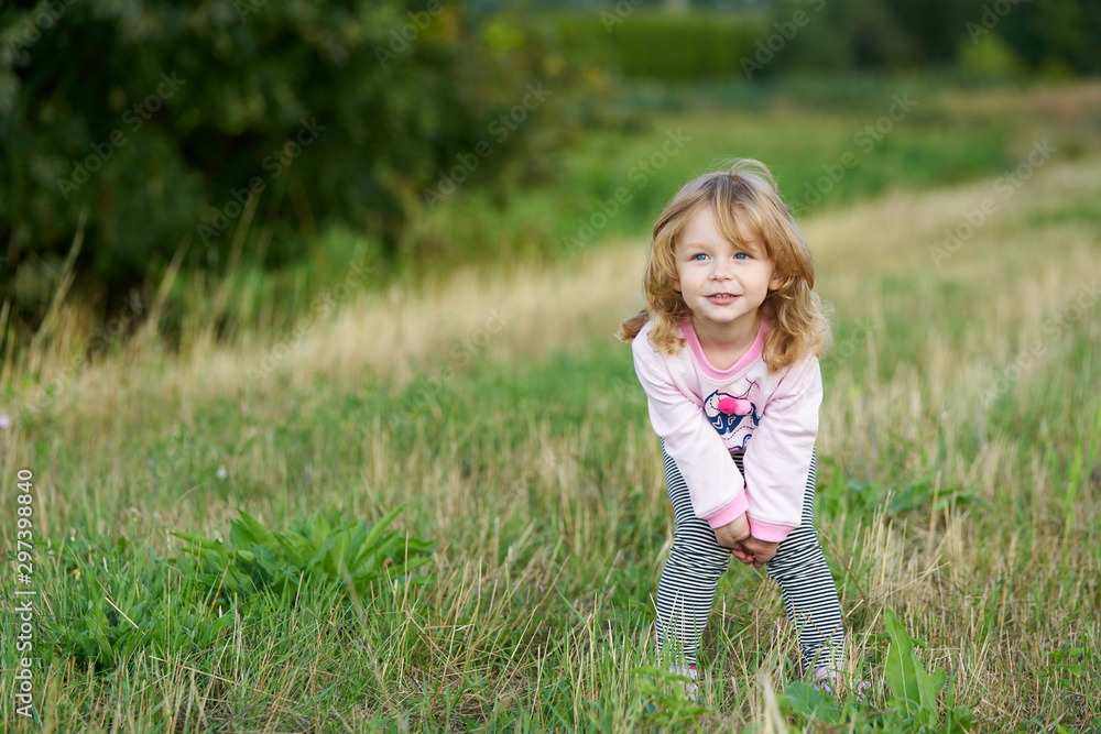 Little blond girl playing in the field Little blond girl playing in the field
