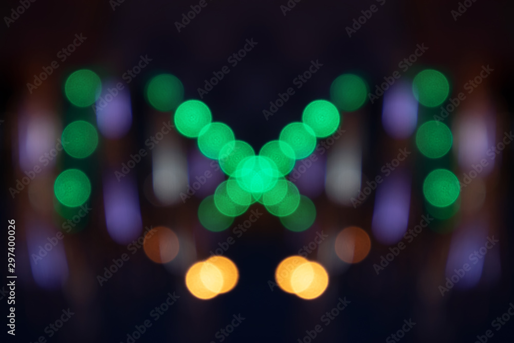 Fototapeta premium Multicolored bokeh patterns on a dark blue background.