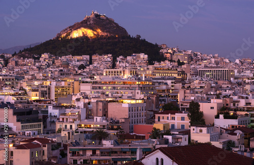 Lycavitos, Lycabettus - a steep, stony conical rocky hill in the center of Athens, the capital of Greece. Evening city landscape photo