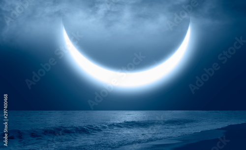 Fototapeta Naklejka Na Ścianę i Meble -  Crescent moon rising over sea with in a dense fog at night 
