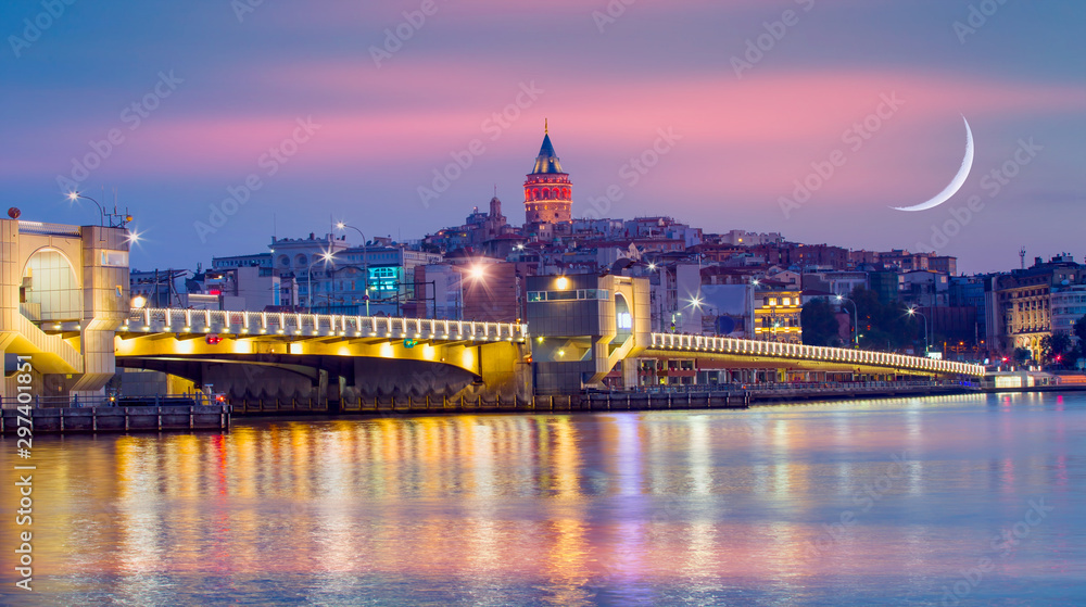 Fototapeta premium Galata Tower, Galata Bridge, Karakoy district and Golden Horn at amazing sunset sky - Istanbul, Turkey