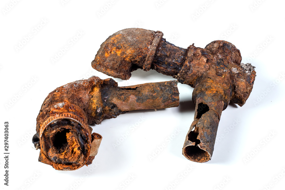 Fragments of old castiron water pipes on white background. After many