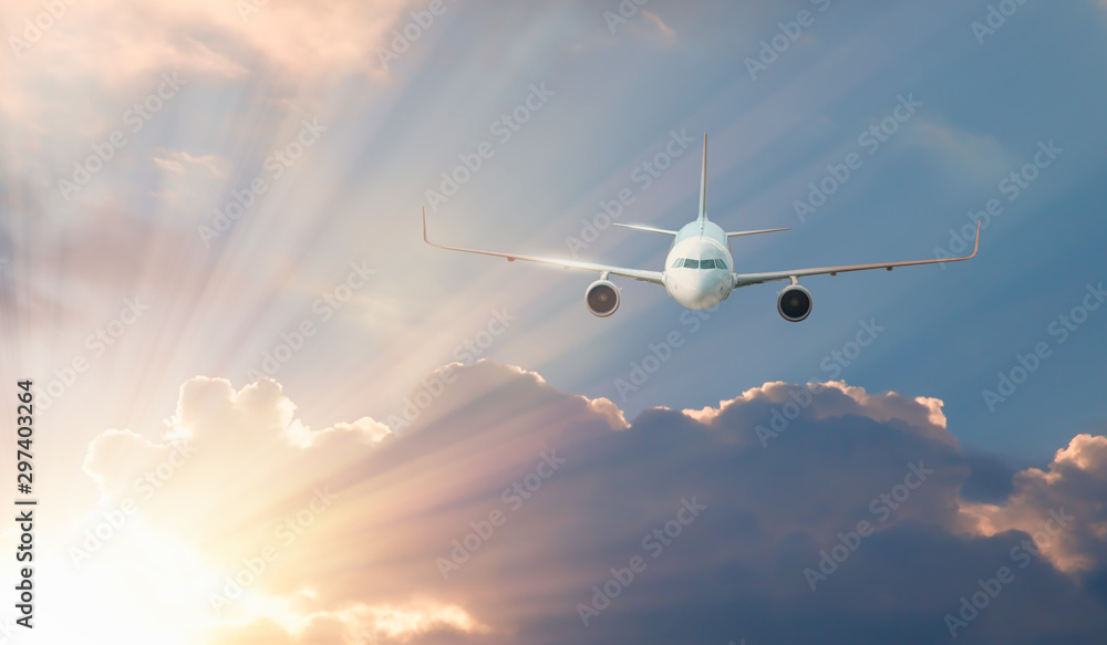 Fototapeta premium Commerical airplane in the sky at amazing sunrise