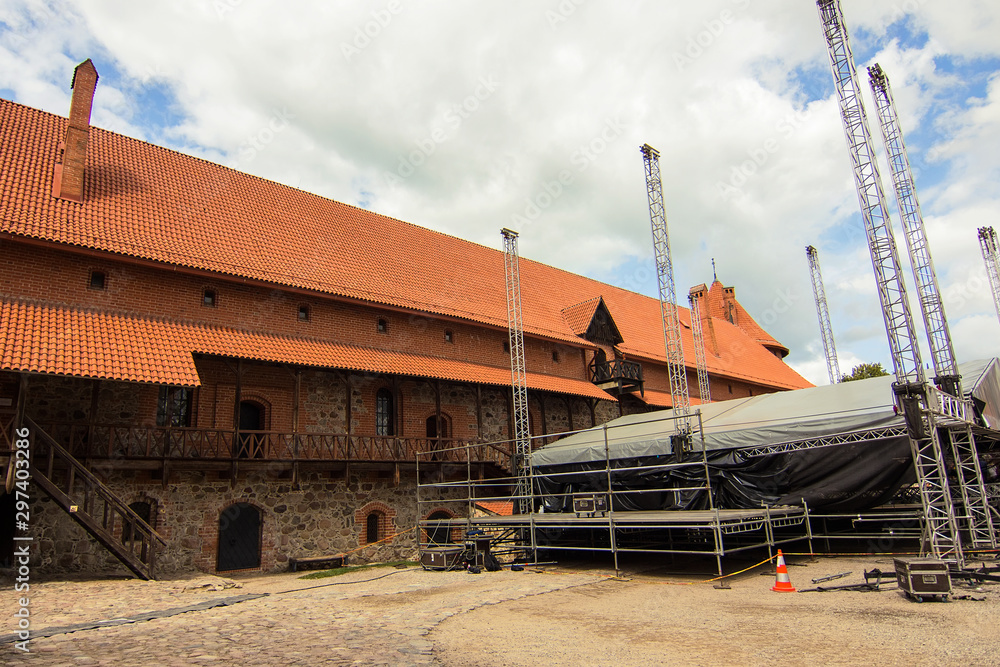 Beautiful view of the courtyard of the medieval gothic Trakai Island Castle with stone walls and towers with red tiled roofs, Lake Galve, Lithuania. Popular Lithuanian landmark. Beautiful view of the courtyard of the medieval gothic Trakai Island Castle with stone walls and towers with red tiled roofs, Lake Galve, Lithuania. Popular Lithuanian landmark.