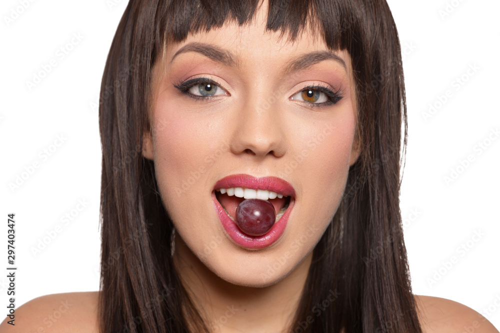 Close up portrait of young woman posing with grapes Close up portrait of young woman posing with grapes