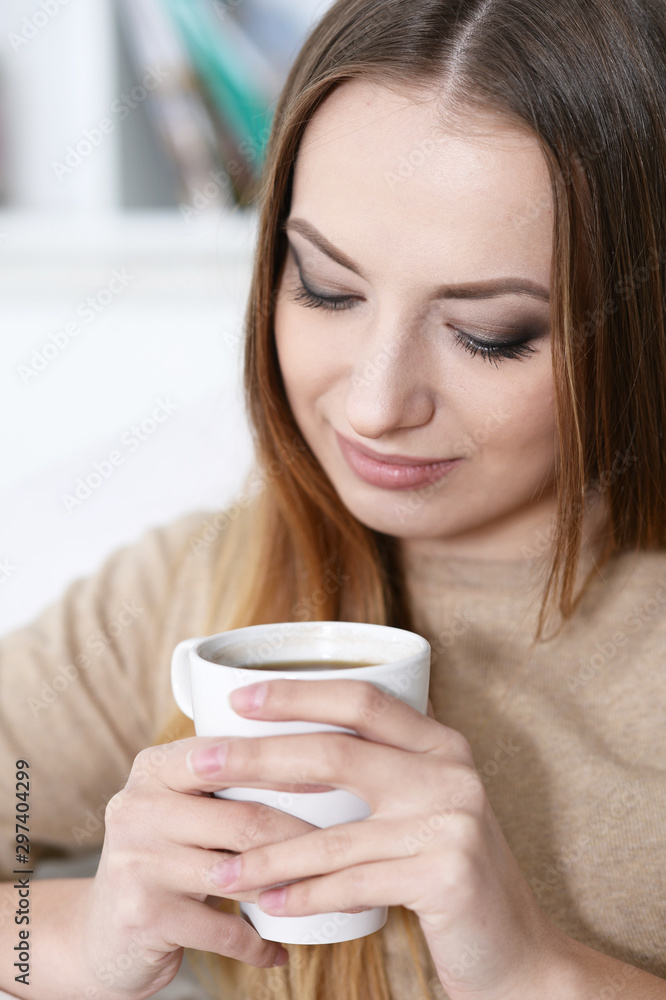 Close up portrait of young beautiful woman holding white cup Close up portrait of young beautiful woman holding white cup