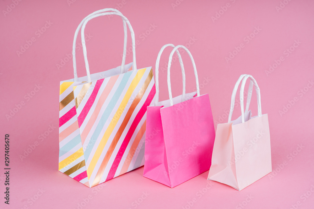 Paper shopping or gift bags on pink background with copy spaсe. Concept sales, shopping, black friday. Giving gift for birthday, christmas and New Year. Paper shopping or gift bags on pink background with copy spaсe. Concept sales, shopping, black friday. Giving gift for birthday, christmas and New Year.