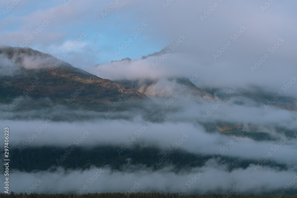 Misty morning with fog around mountains and valley