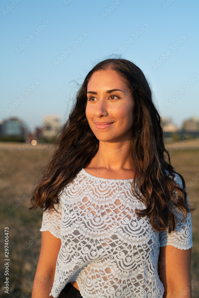 Fototapeta premium Portrait of a young woman watching sunset
