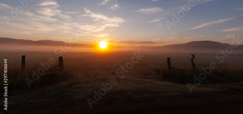 Morning sunrise over high mountain meadow in late autumn