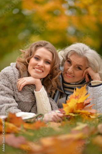 Close up portrait of smiling senior woman with adult daughter