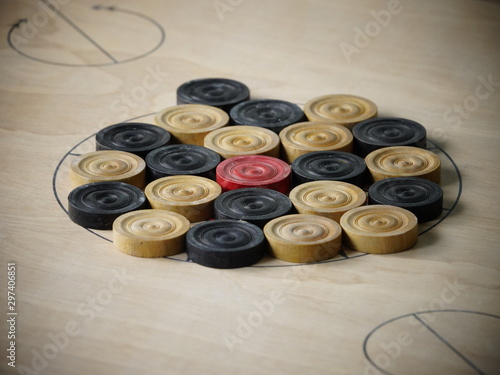 Side view of wooden carrom board game coins arranged for playing match. Concept of teamwork, cooperation, activities, success