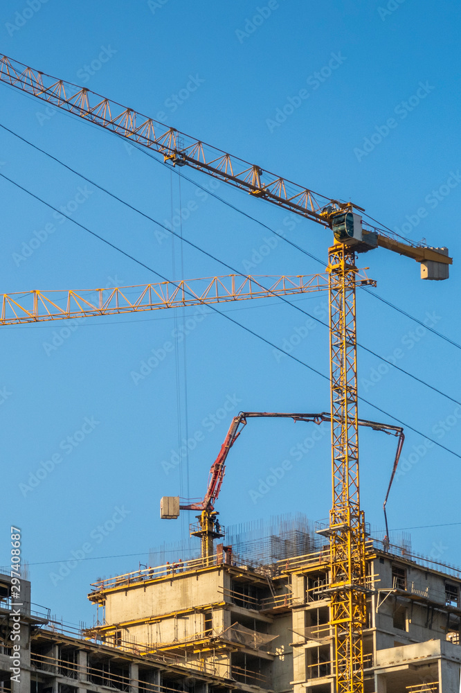 Building construction site with 2 cranes on sunny summer day.. Building construction site with 2 cranes on sunny summer day..