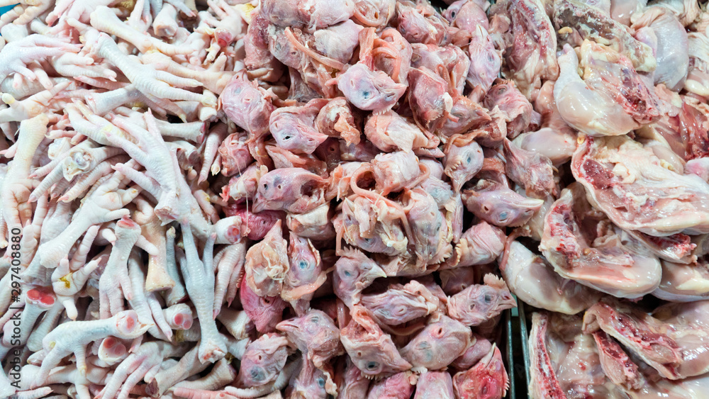 Paws chicken on the counter market. Chopped chicken. Chicken heads. cold chicken feet and head after slaughtering Paws chicken on the counter market. Chopped chicken. Chicken heads. cold chicken feet and head after slaughtering