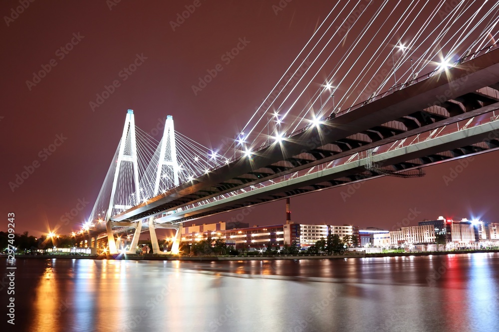 Obraz premium big cable-stayed bridge over the river at night with colorful bright lighting