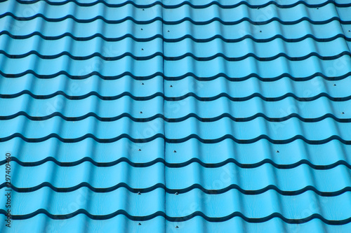 Turquoise metal tiles on roof of the house. Modern roofing materials