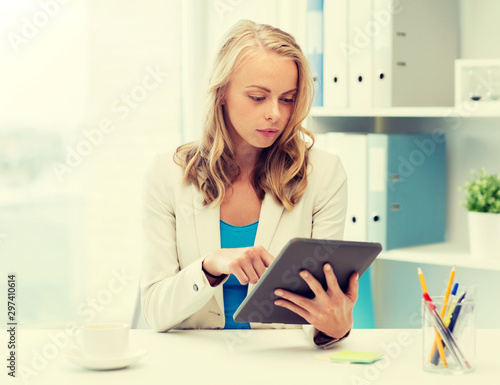 office, business, education, technology and people concept - businesswoman or student with tablet pc computer sitting at table