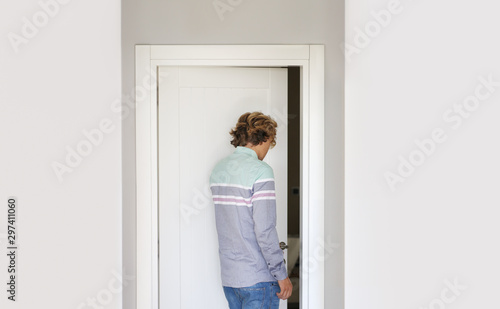 Man opening the door of him home.