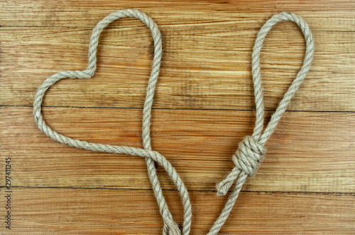 loop and heart of rope on wooden background