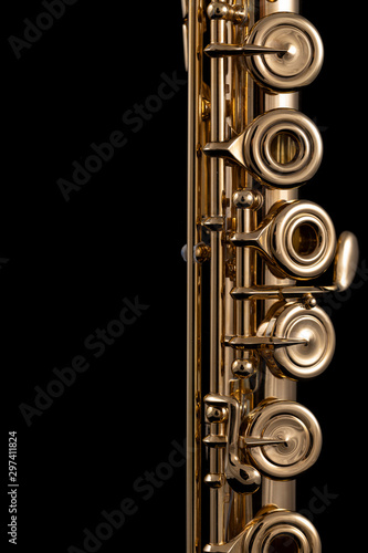 Slika na platnu A part of a gold plated flute on a black background