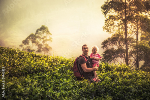 Happy father explorer with child daughter among tropical thickets in the mountains during vacation looking at beautiful scenery as family travelling lifestyle 