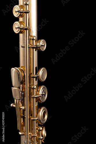 Fotografia, Obraz A part of a gold plated flute on a black background