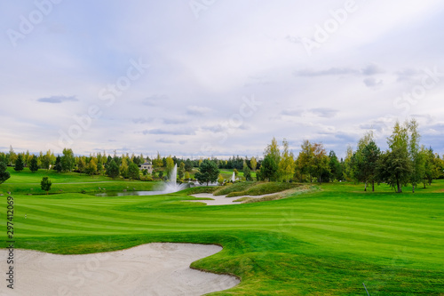 Landscape. Golf course with trees  shrubs  lake  bridge and fountain.