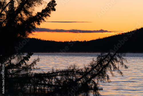 Sunrise during autumn season with reflections on lake in Alaska