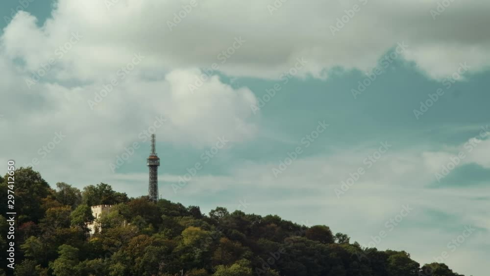 Prague, Czech Republic - September 2019: View of hill with Petrin Lookout Tower and fast moving clouds in background. 4K resolution. Prague, Czech Republic - September 2019: View of hill with Petrin Lookout Tower and fast moving clouds in background. 4K resolution.