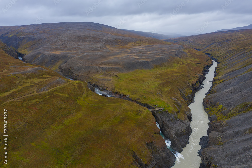 Obraz premium Studlagil basalt canyon, Iceland. One of the most wonderfull nature sightseeing in Iceland. Aerial drone shot in september 2019