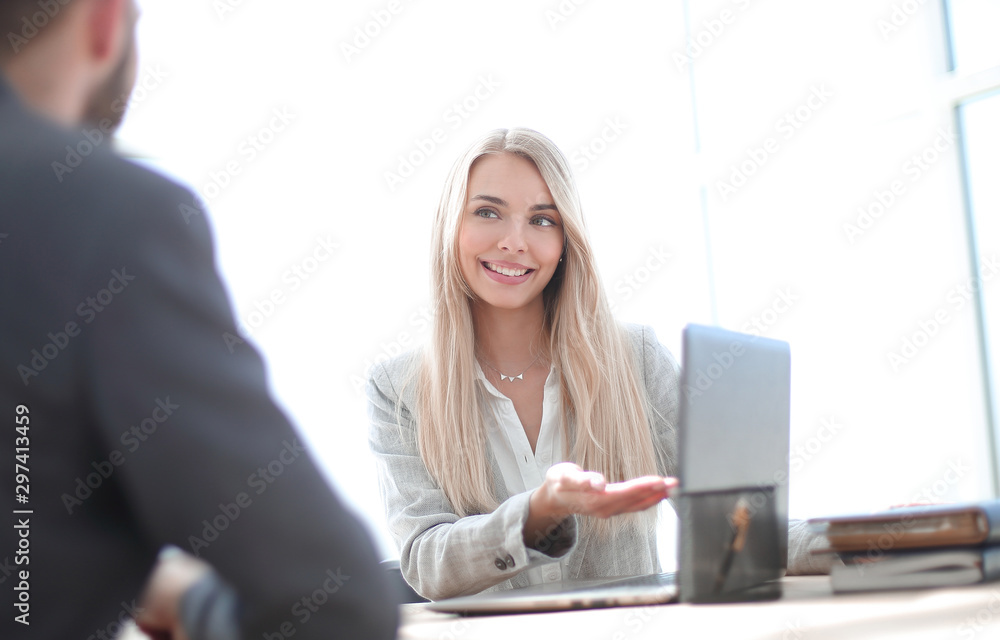 smiling businesswoman explaining something to her colleague smiling businesswoman explaining something to her colleague