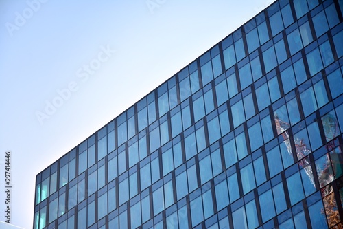 Panoramic and perspective wide angle view to steel light blue background of glass office building commercial modern city of future. Business concept of success industry tech architecture. 