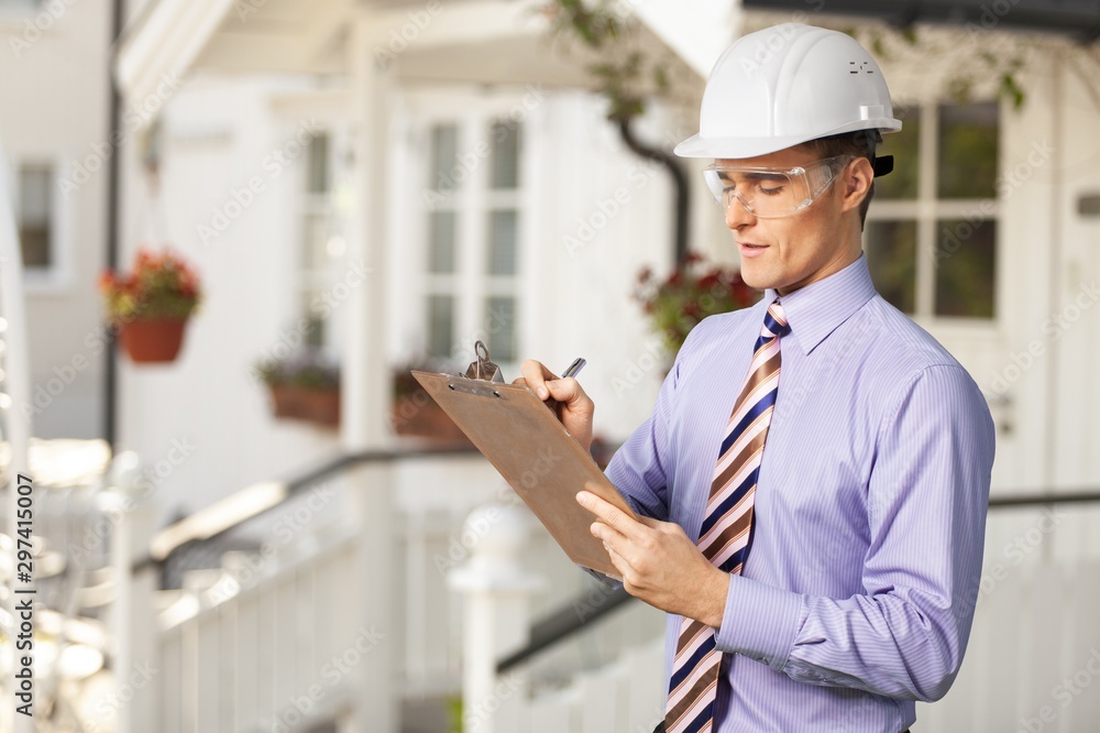Engineer taking a note. Focused man in