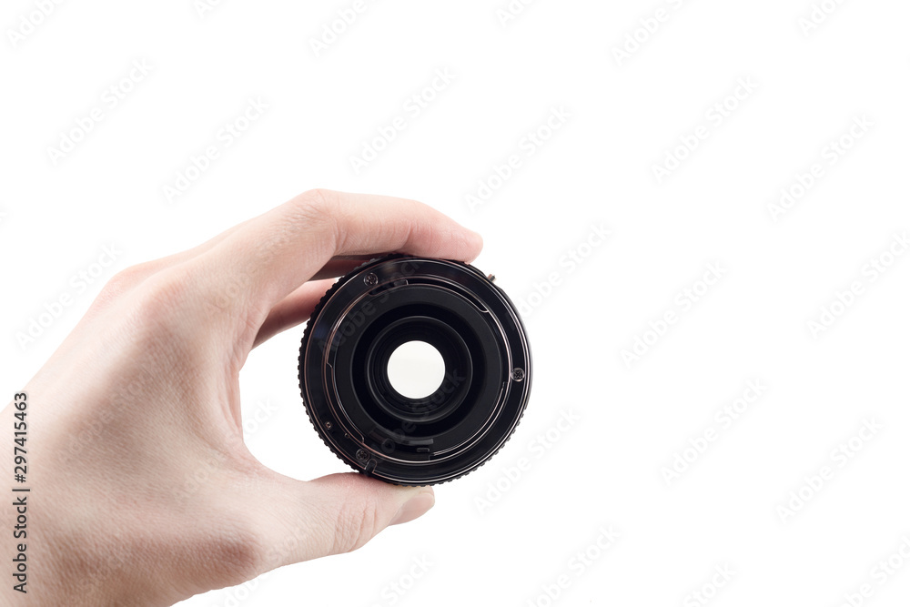 view of the back lens of the detachable camera lens in hand, the back of the lens, mount to the camera, isolated on white background